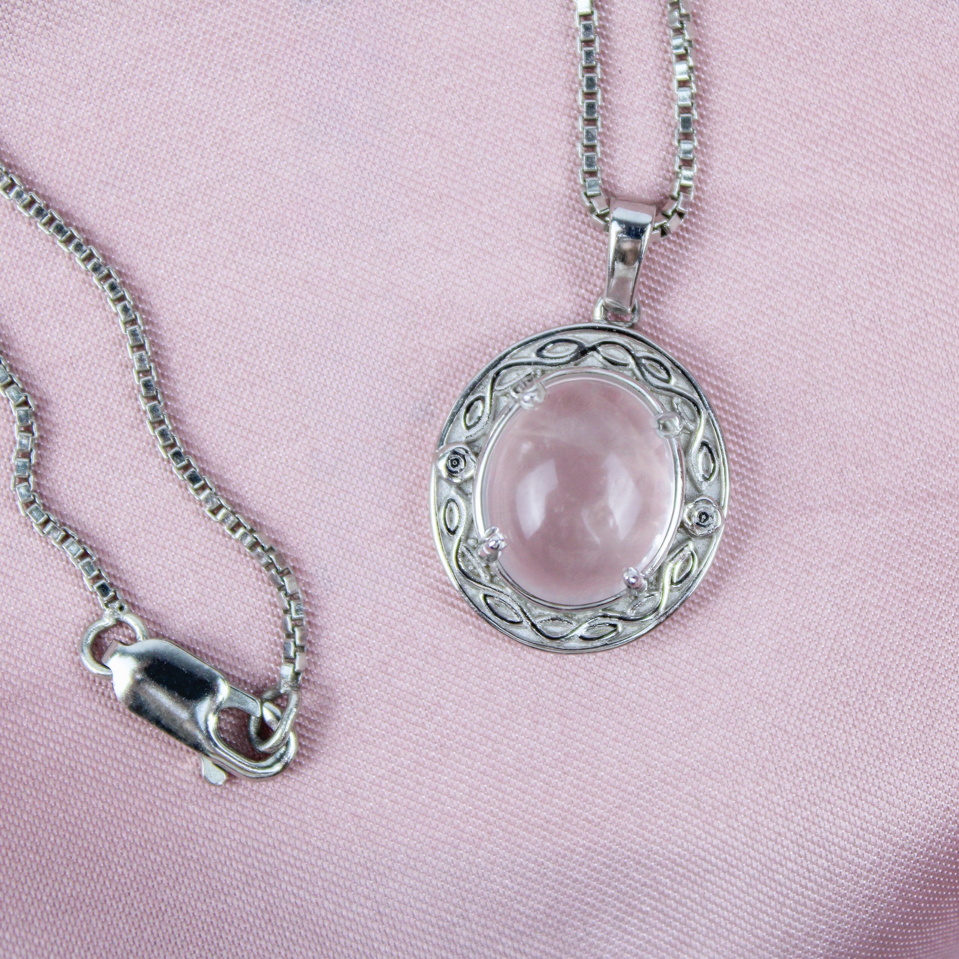 Sterling Silver Romantic Heir  pendant with a pink quartz gemstone on a pink background