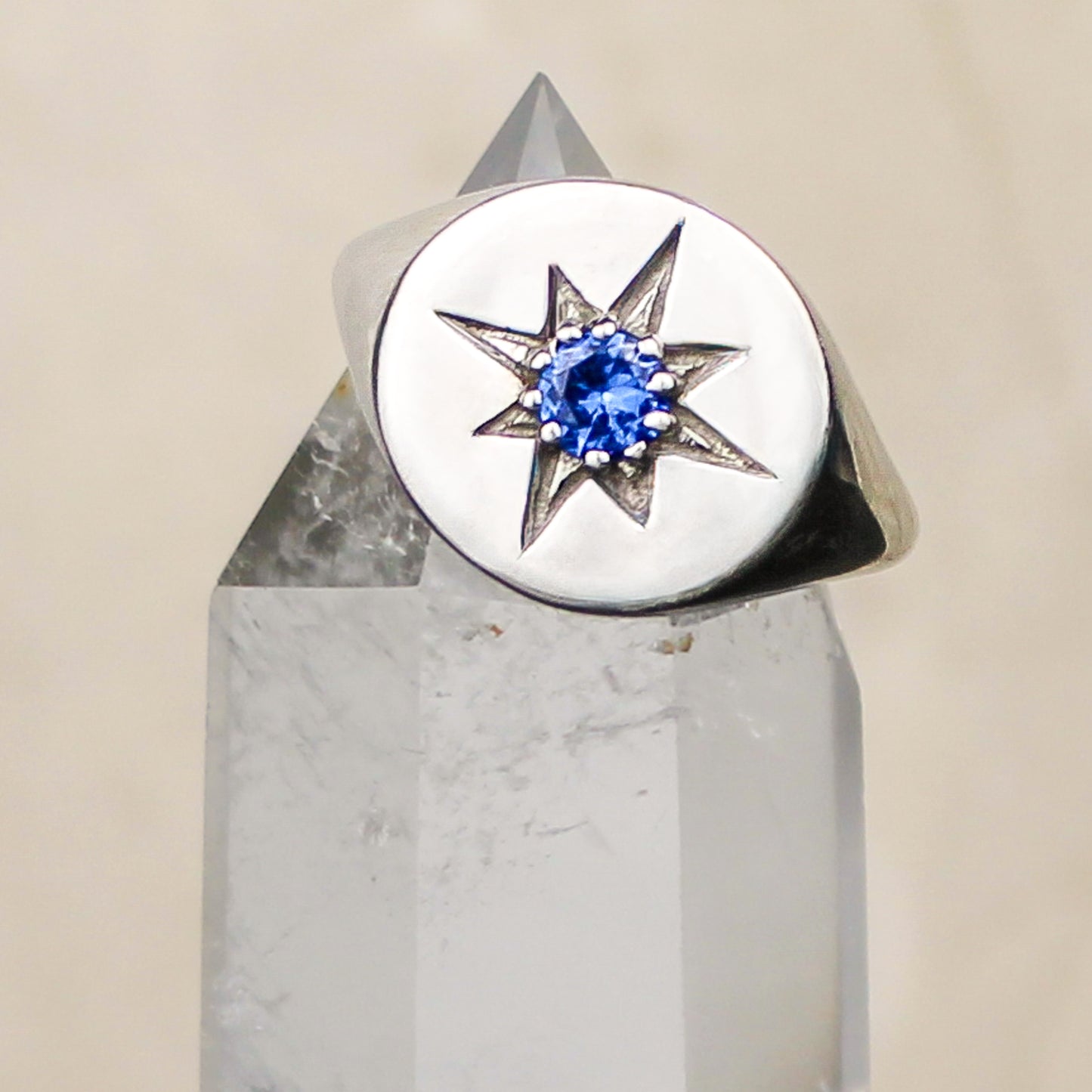 Wayfinder Ring sterling silver sitting on top of crystal, engraved north star signet ring with blue CZ, Ether Jewelry