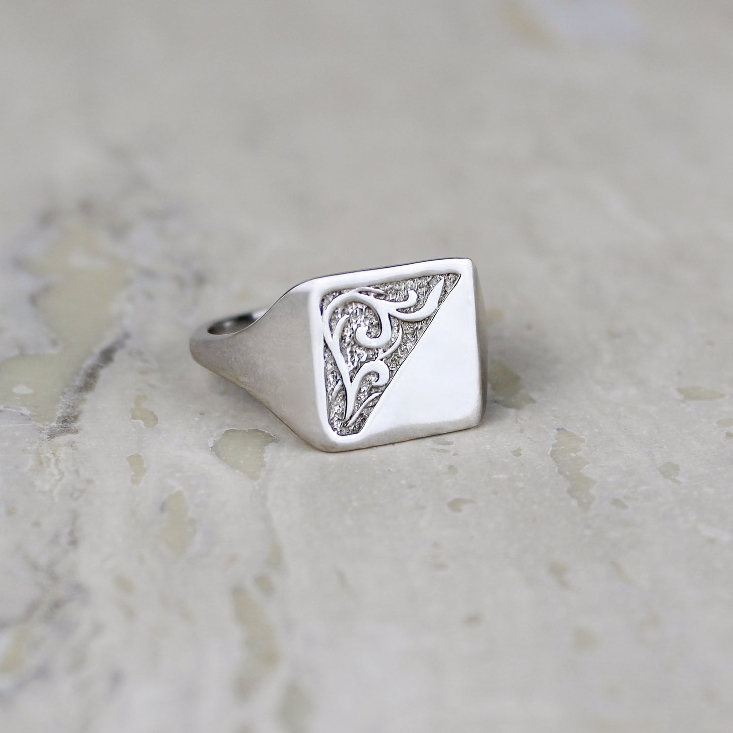 sterling Silver architect square signet ring with intricate design on a marble surface