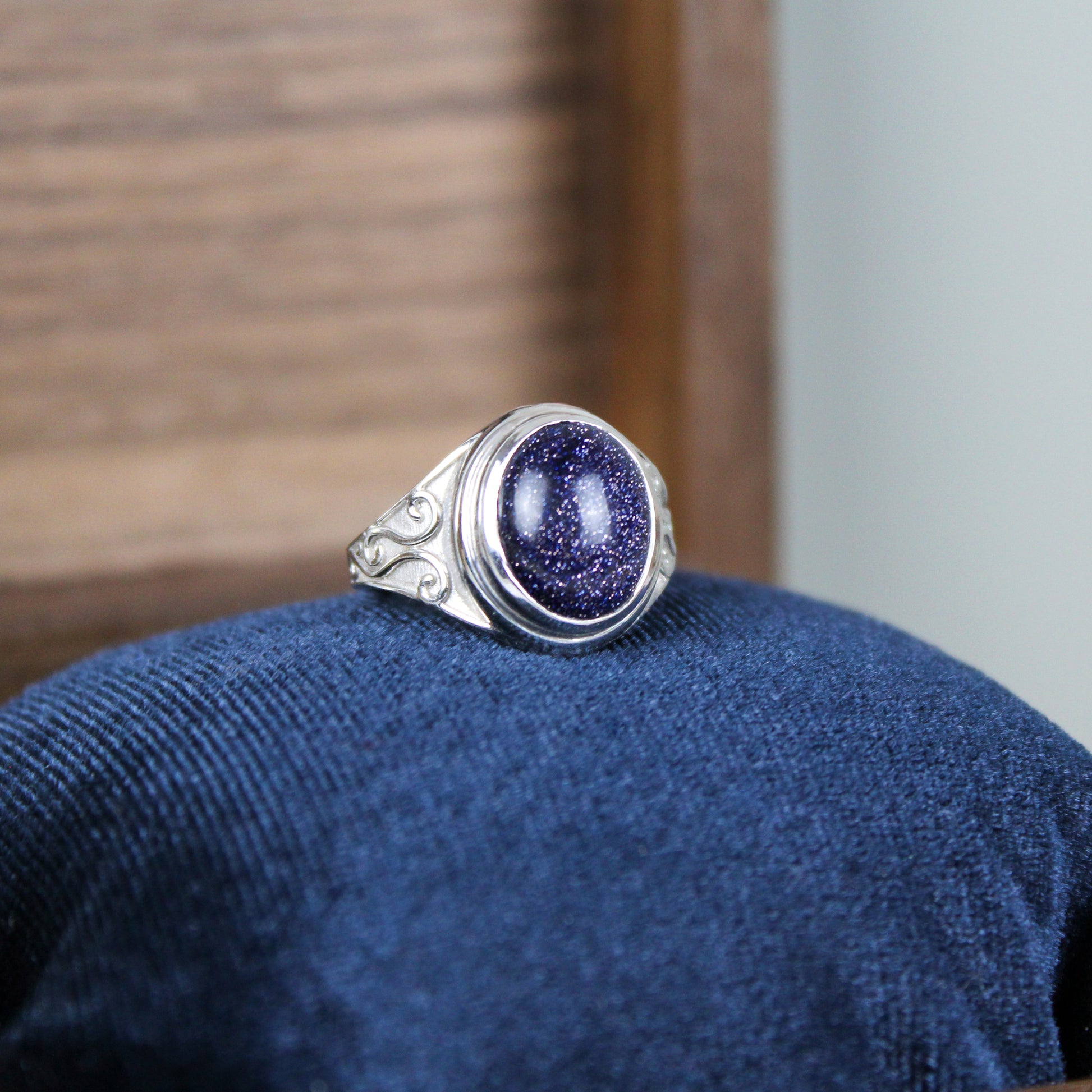 sterling Silver night keeper signet ring with a blue sandstone gemstone on a blue cushion