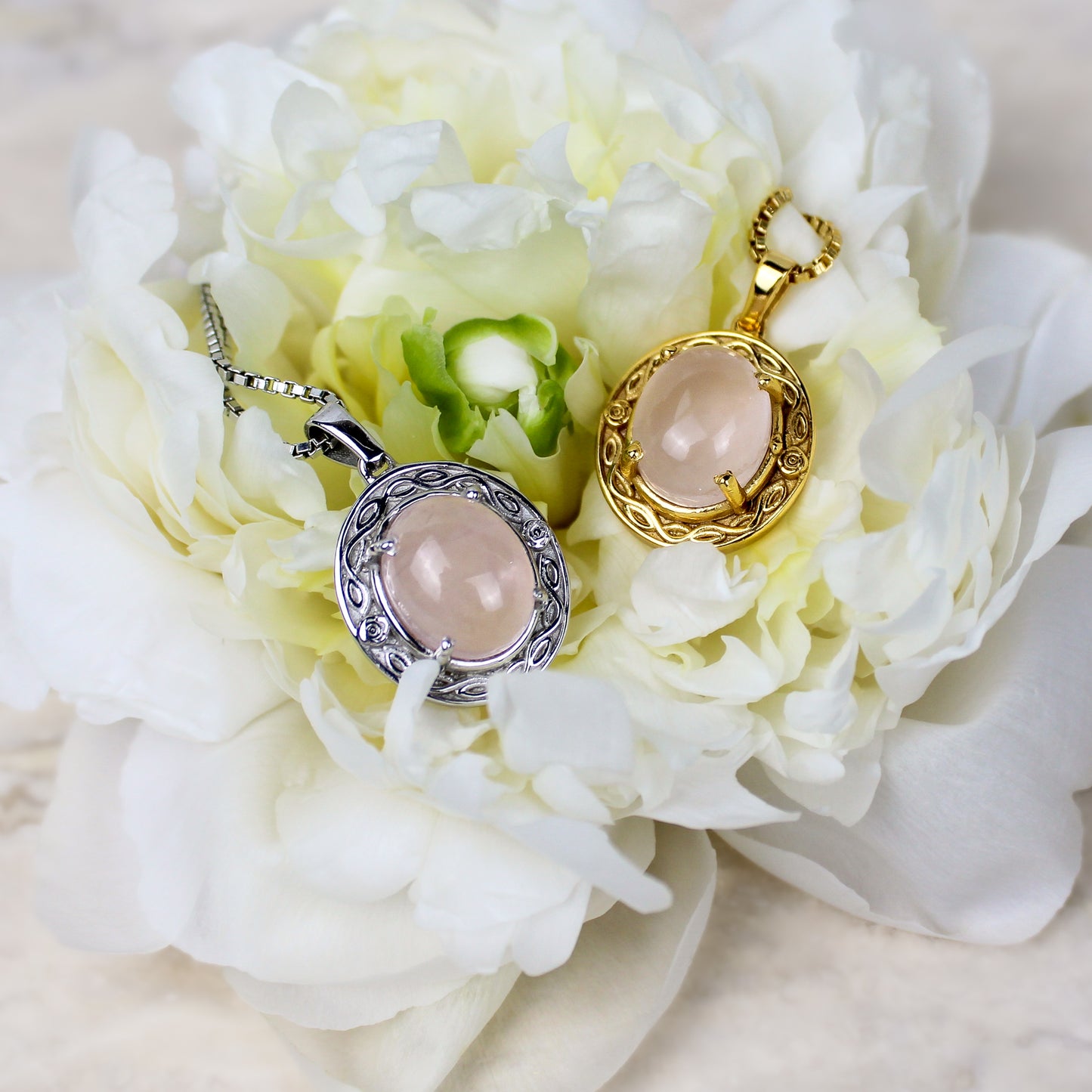 Romantic Heir pendants with pink stones on a bed of white flowers