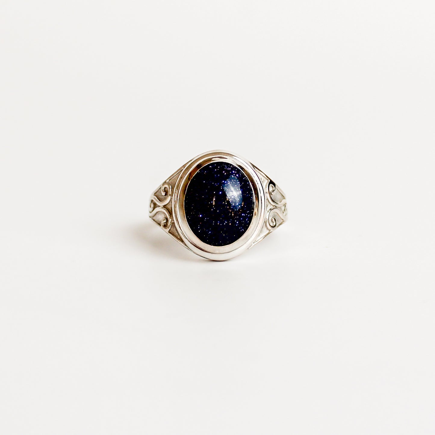Night Keeper Ring in sterling silver, oval blue sandstone cabochon in bezel setting with scroll engraved shoulders, Ether Jewelry