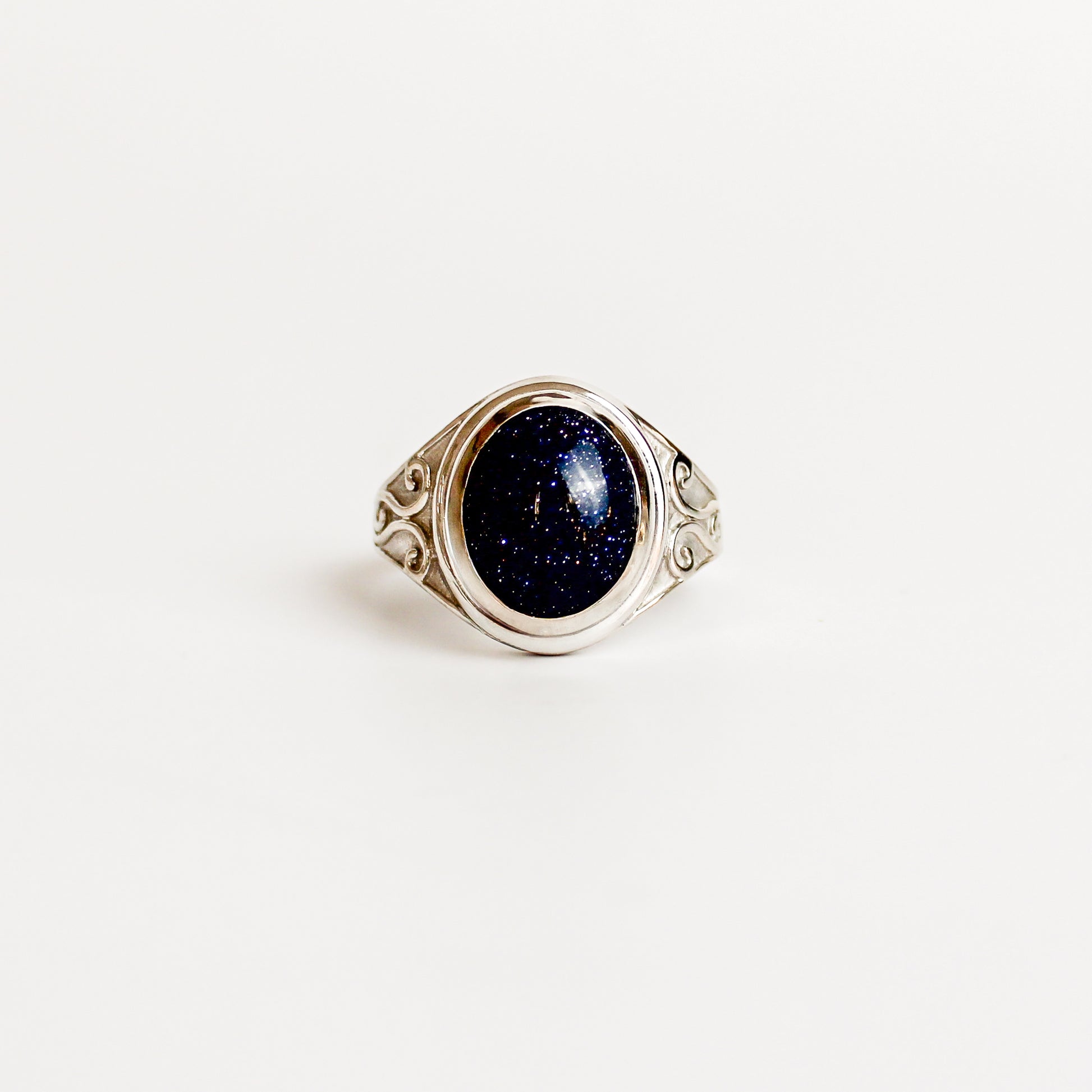Night Keeper Ring in sterling silver, oval blue sandstone cabochon in bezel setting with scroll engraved shoulders, Ether Jewelry