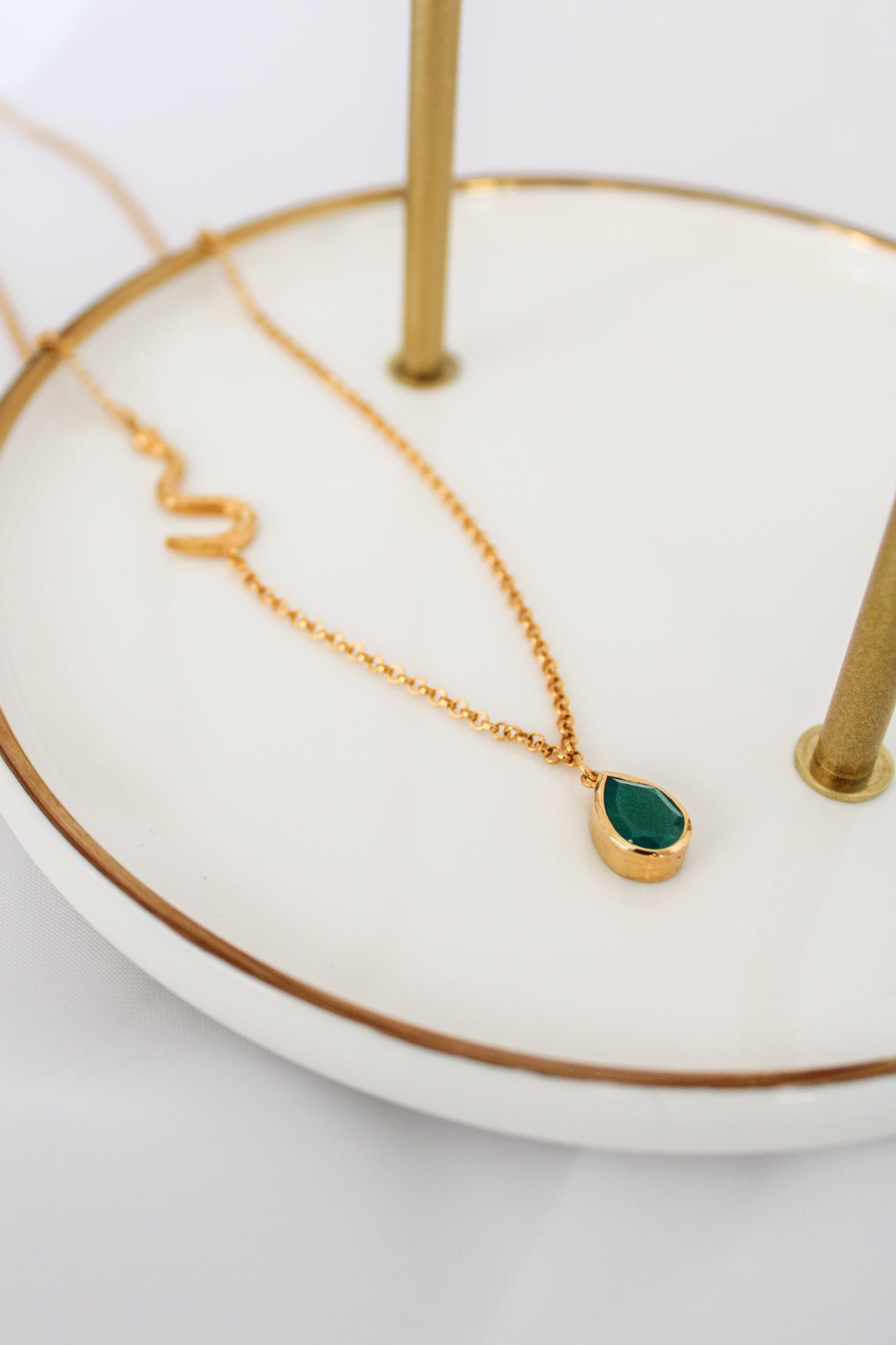 Devoted Necklace in 18k gold vermeil staged on white jewelry tray, asymmetric snake chain and green onyx pendant, Ether Jewelry