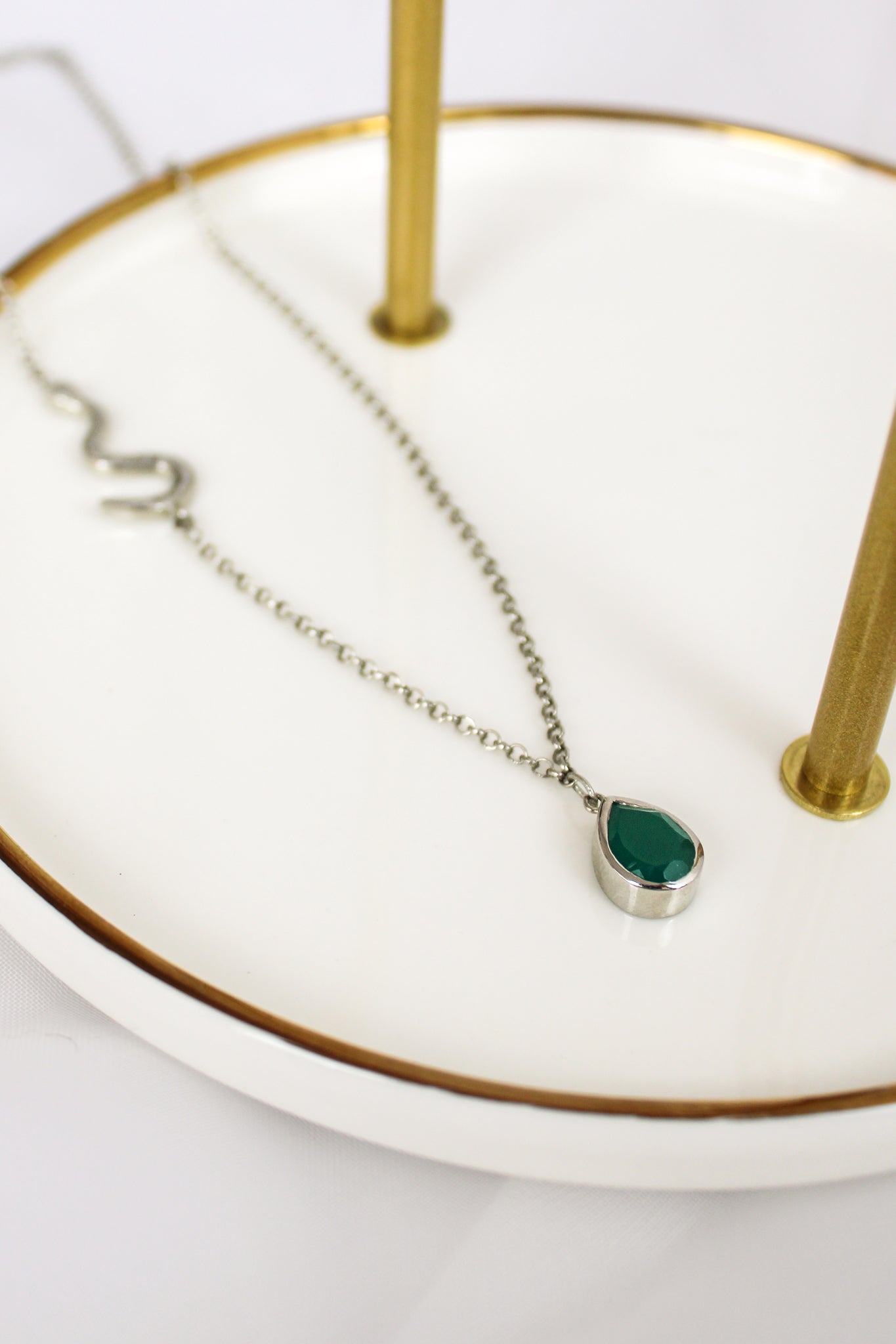 Devoted Necklace in sterling silver staged on white jewelry tray, asymmetric snake chain and green onyx pendant, Ether Jewelry