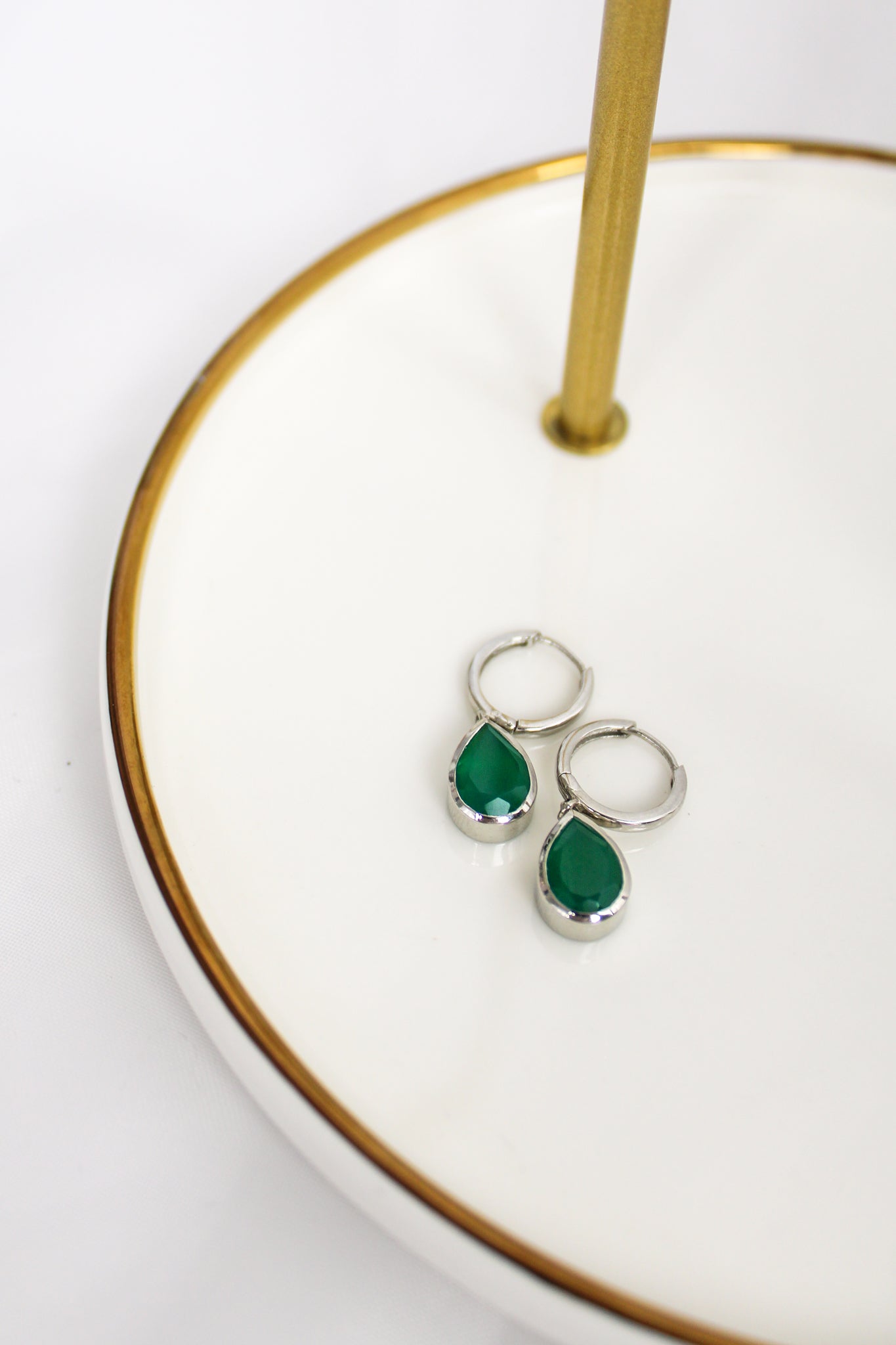 Devoted Earrings in sterling silver staged on white jewelry tray, bezel-set green onyx teardrop drops, Ether Jewelry