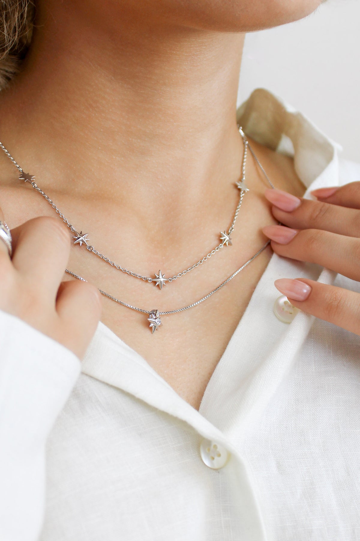 Sterling silver Juno Necklace worn on model layered with Lucida Necklace, multi north star charm station necklace, Ether Jewelry