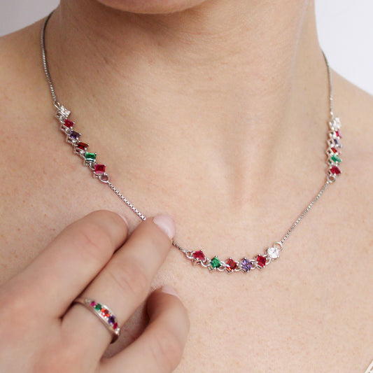 Linked Love Necklace in sterling silver on model touching gemstones, repeating acrostic REGARD CZ tennis necklace, Ether Jewelry