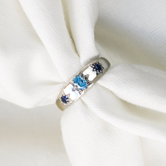 Letters from Roma Ring in sterling silver over white fabric, domed light blue and blue CZ gypsy band, Ether Jewelry