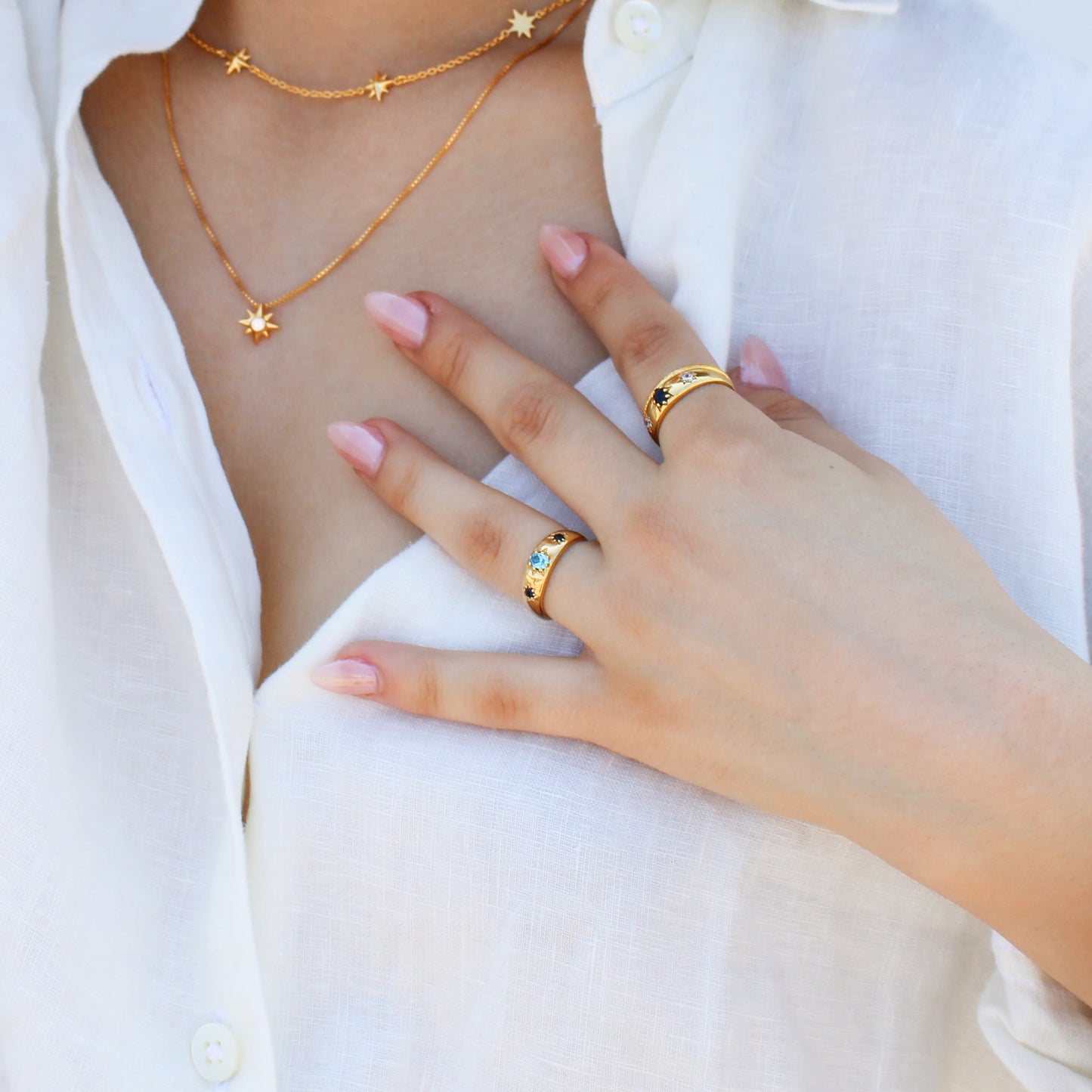 Letters from Roma Ring in 18k gold vermeil on model with matching necklaces, domed light blue CZ gypsy set band side view, Ether Jewelry