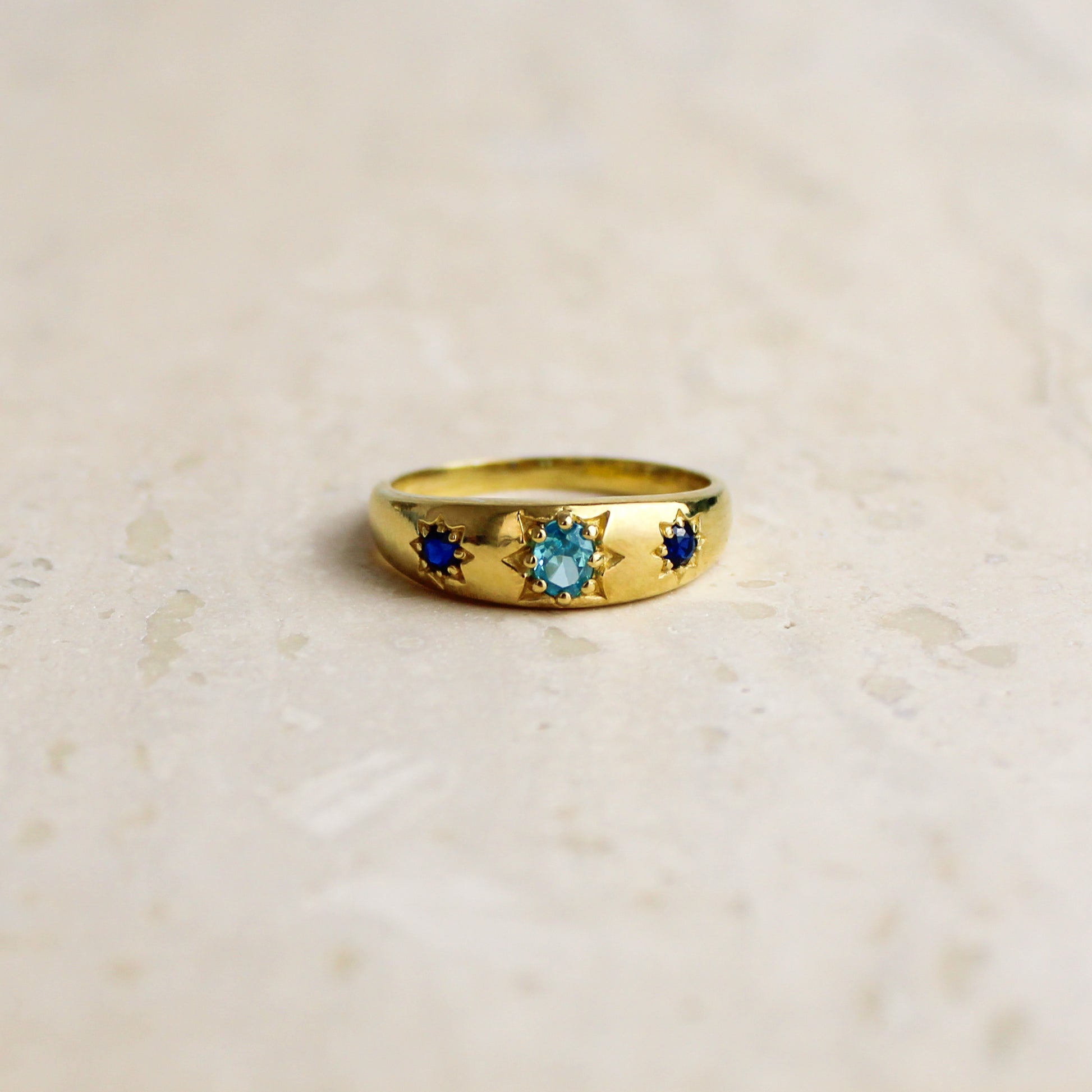 Letters from Roma Ring 18k gold vermeil on marble, domed three stone gypsy set band with light blue and blue CZ, Ether Jewelry