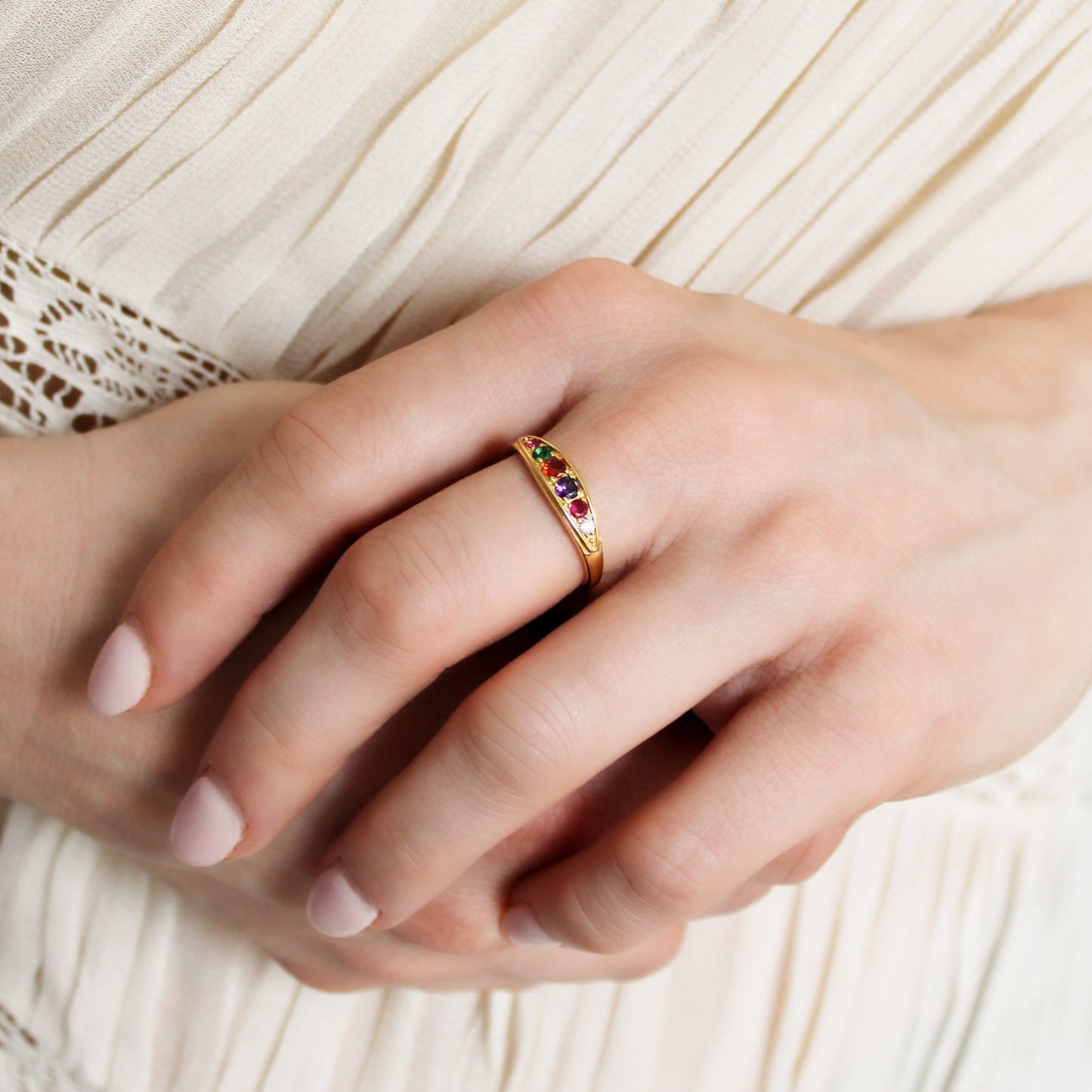 18k gold vermeil Love Letter Ring on model holding wrist, domed multistone acrostic band close-up, Ether Jewelry