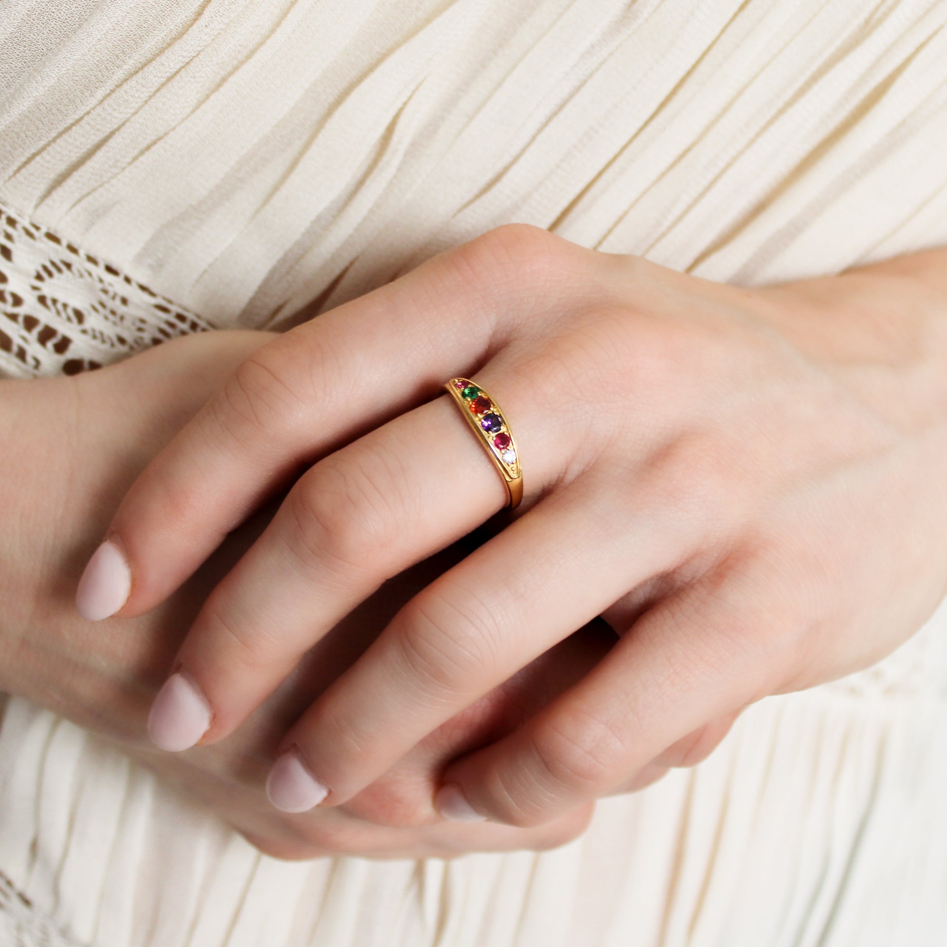 18k gold vermeil Love Letter Ring on model holding wrist, domed multistone acrostic band close-up, Ether Jewelry
