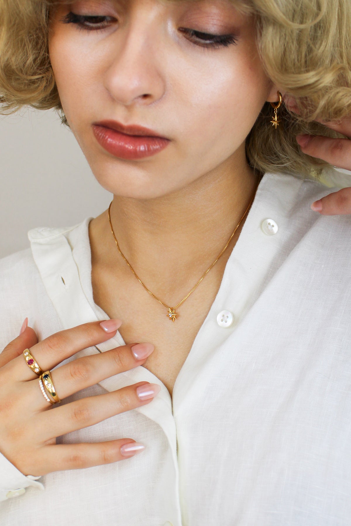 Lucida Necklace in 18k gold vermeil on model front view, with matching jewelry, delicate north star CZ pendant necklace, Ether Jewelry