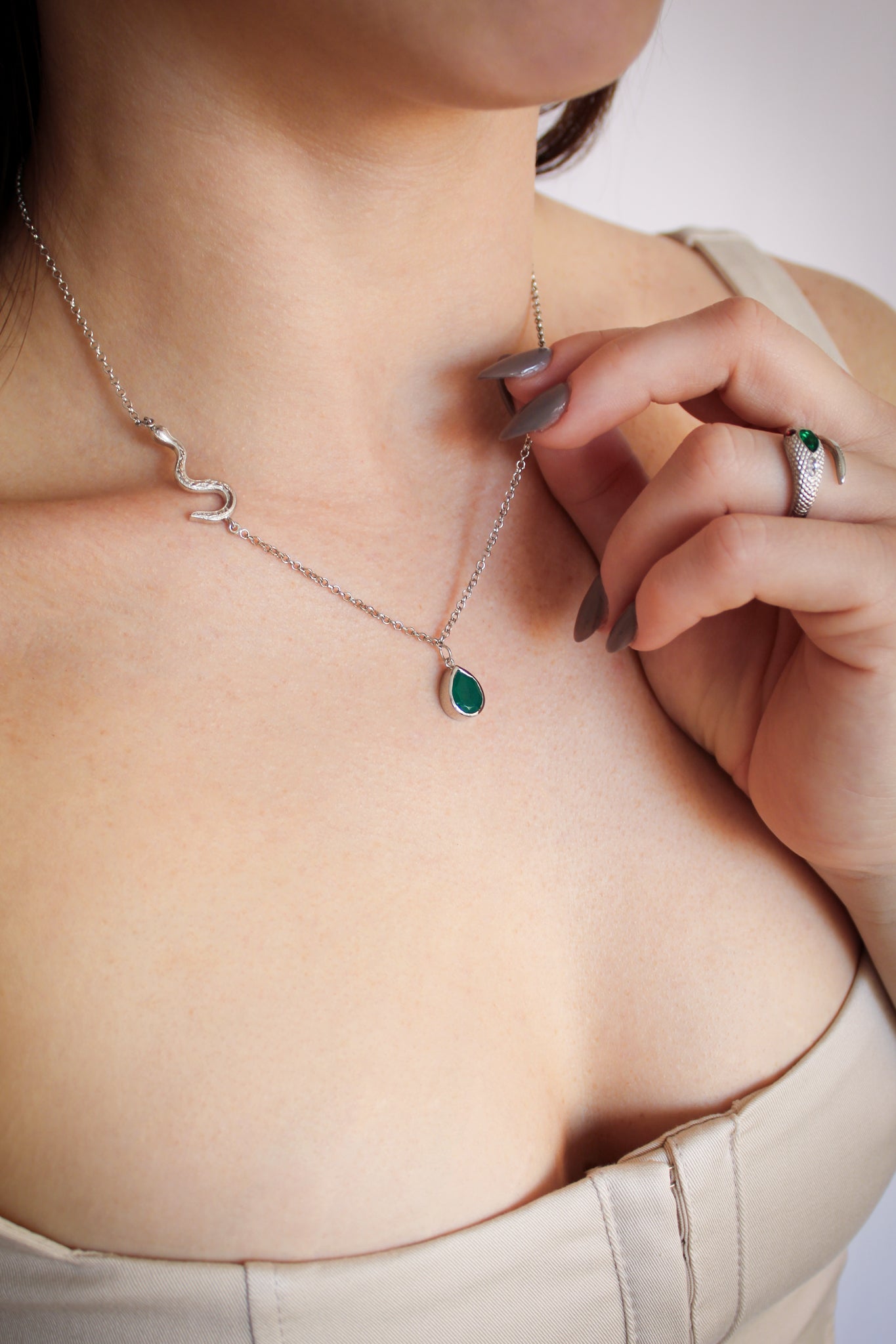 Sterling silver Devoted Necklace on model, hand touching green onyx pendant with ring, serpent chain detail, Ether Jewelry