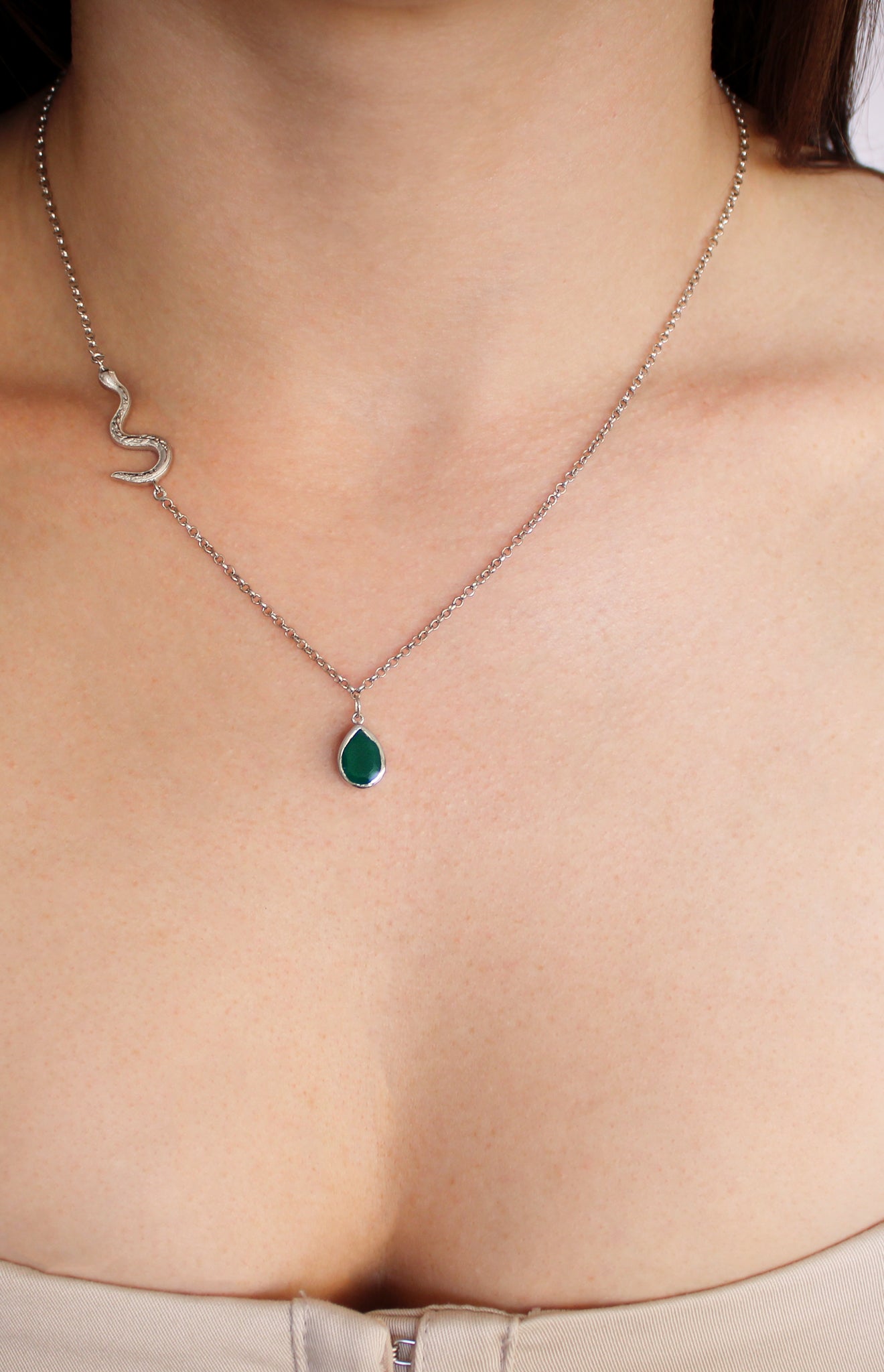 Devoted Necklace in sterling silver worn on model, asymmetric serpent chain with green onyx teardrop pendant, front view, Ether Jewelry