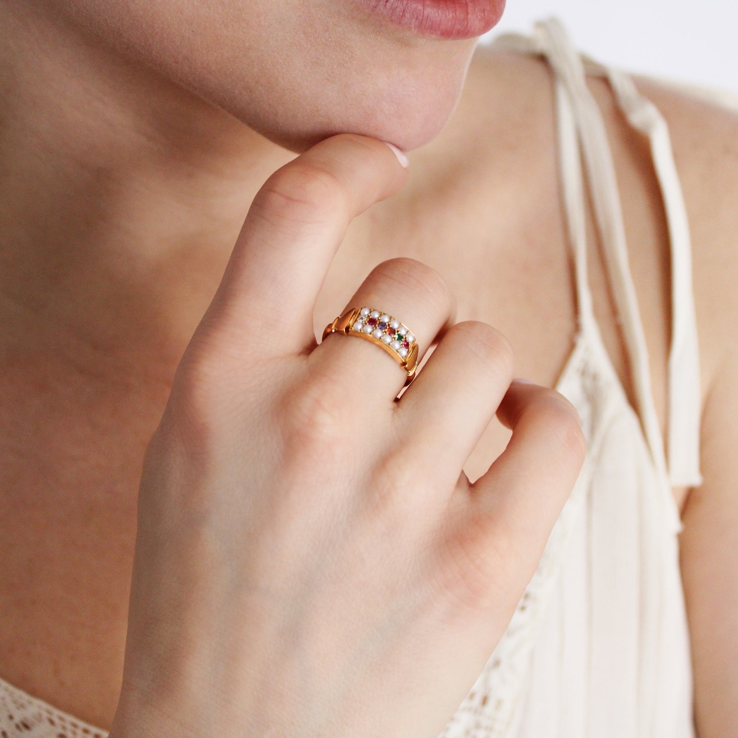 Regent Ring in 18k gold vermeil worn on model hand in beige dress, pearl-paved REGARD acrostic signet ring, Ether Jewelry
