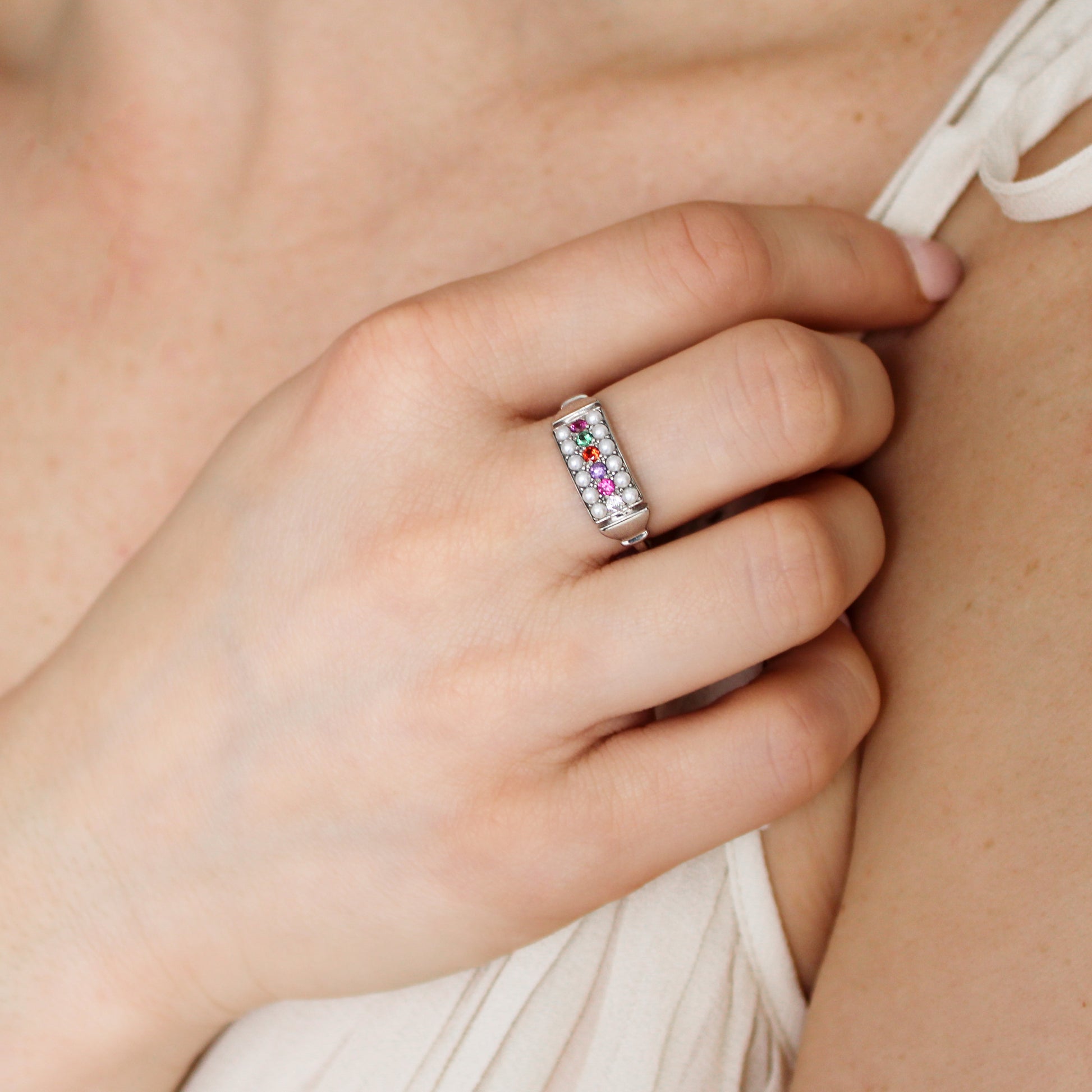 Sterling silver Regent Ring on model holding up hand, cultured pearl and acrostic gemstone signet ring, Ether Jewelry