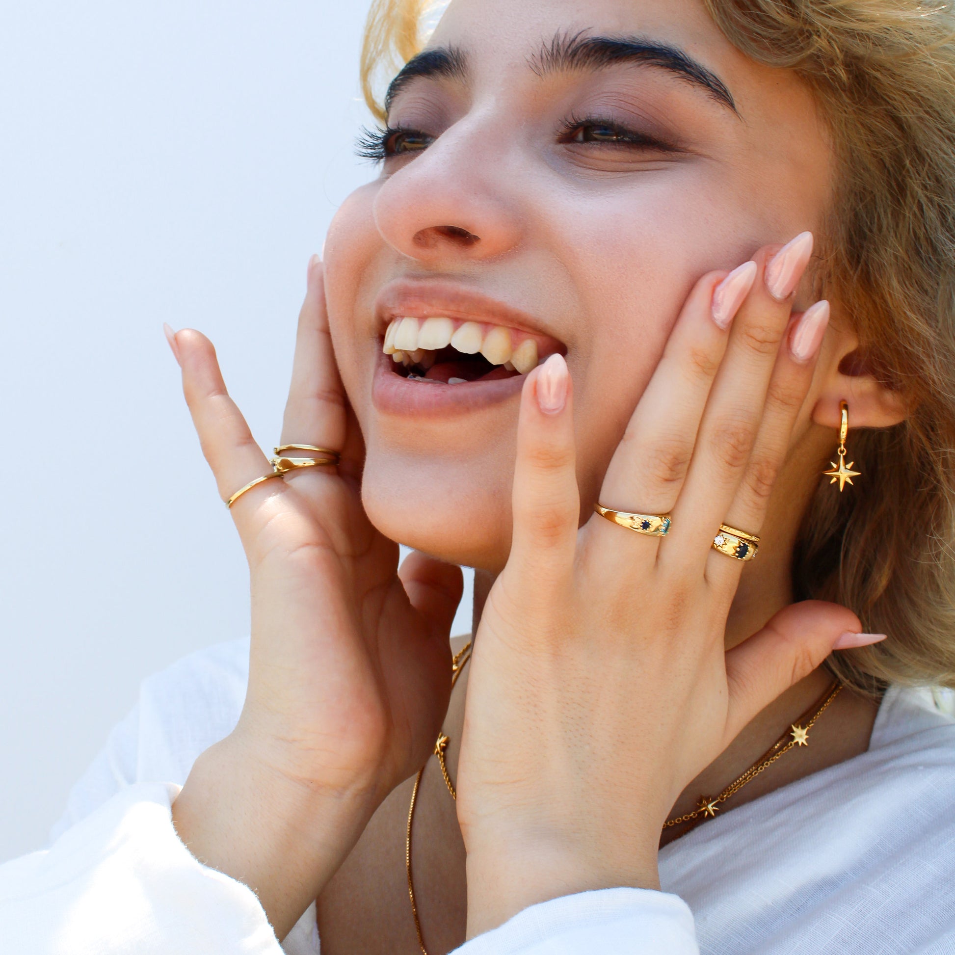 Victorian Roma Ring in 18k gold vermeil model holding face wearing roma rings and matching star necklaces, Ether Jewelry
