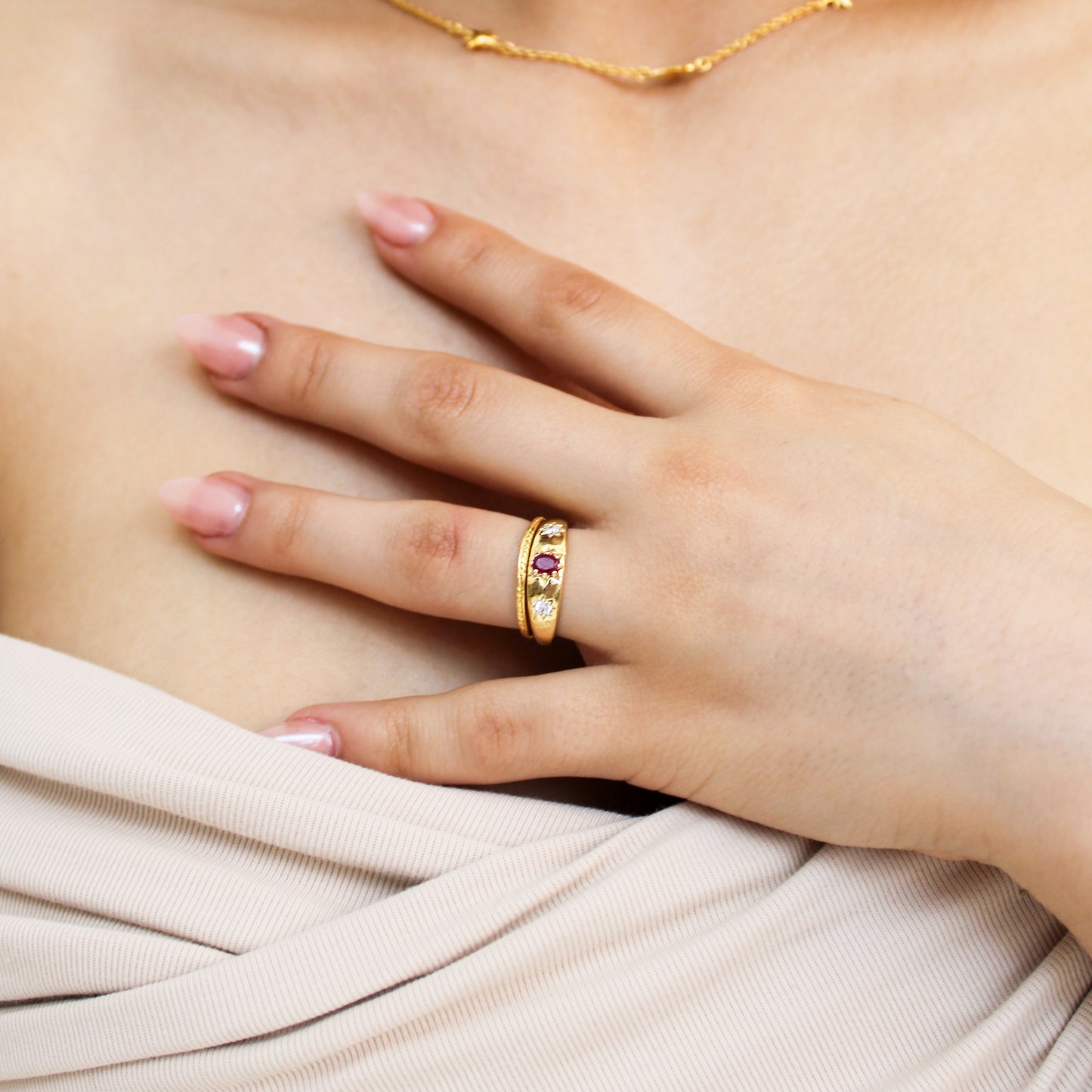 Rose from Roma Ring 18k gold vermeil close-up on model hand, domed pink CZ center with star-set white CZ stones, Ether Jewelry