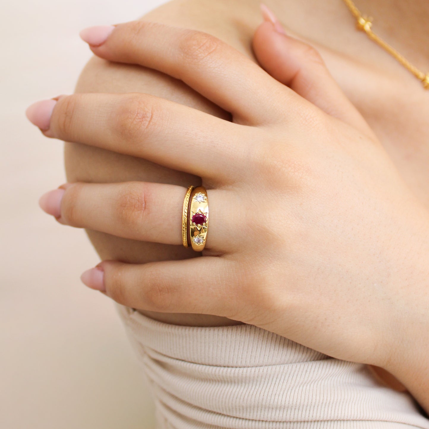 Rose from Roma Ring 18k gold vermeil close-up on model hand, domed pink CZ center with star-set white CZ stones, Ether Jewelry