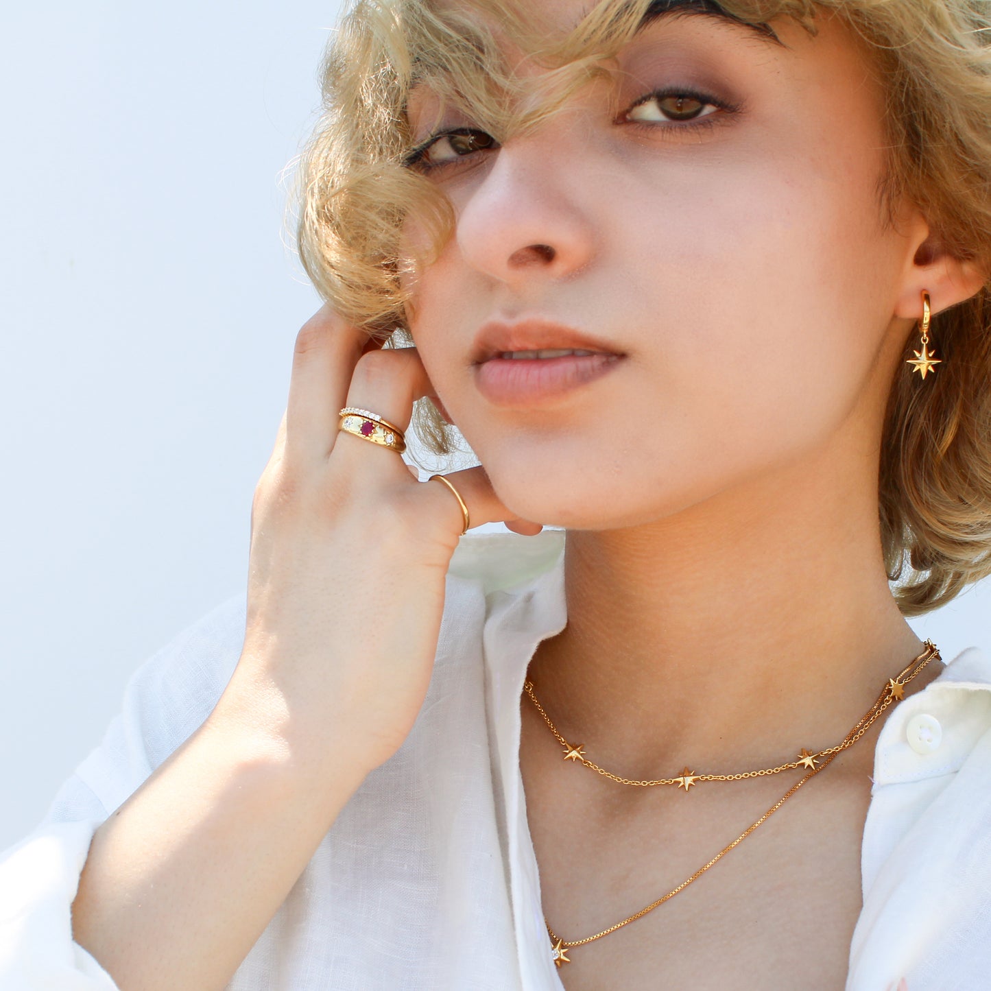 18k gold vermeil Rose from Roma Ring on model with Juno collection in front of face, Ether Jewelry