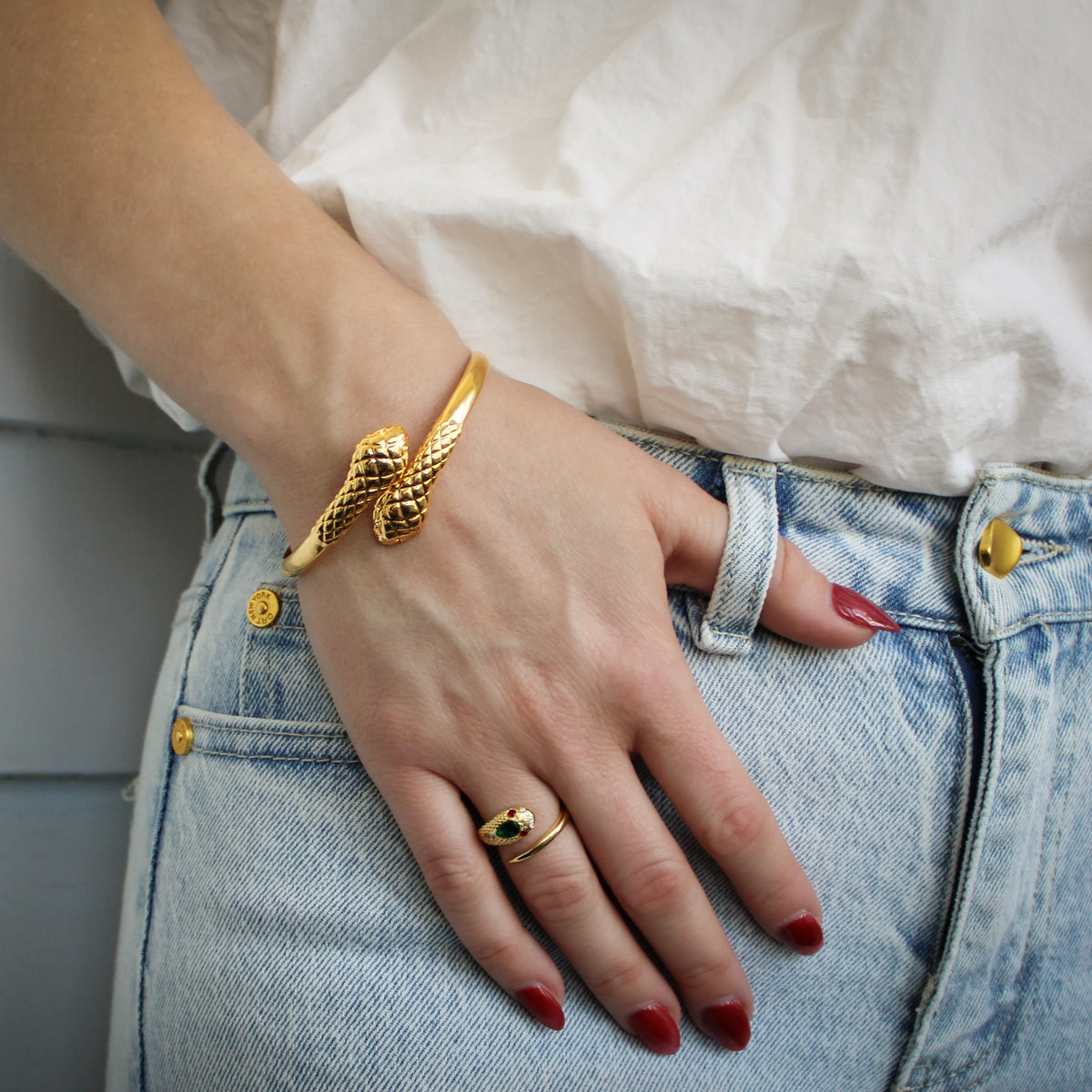 Serpentine Bracelet in 18k gold vermeil worn on model wrist, coiled snake bangle with scale texture, Ether Jewelry