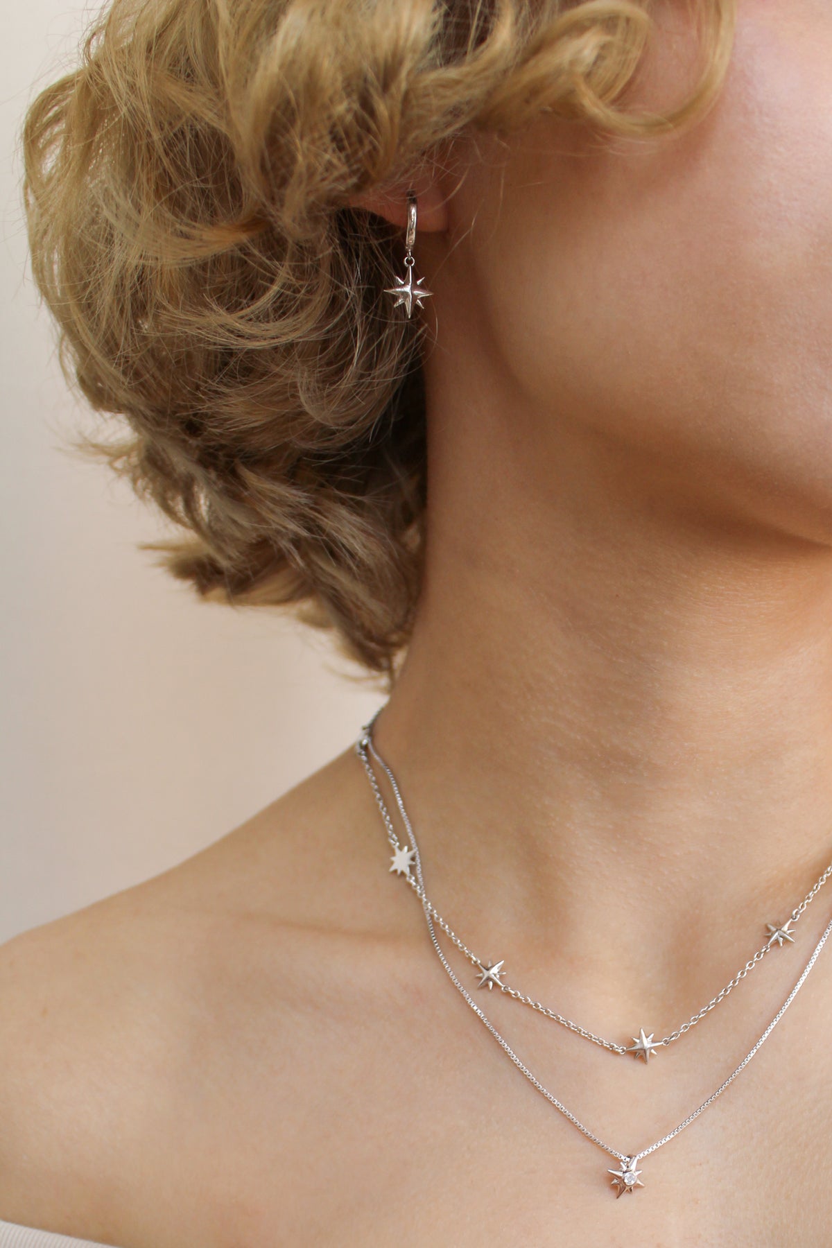 Sterling silver Stella Hoops on model with Juno Necklace and Lucida Necklace, north star charm huggie hoop earrings, Ether Jewelry