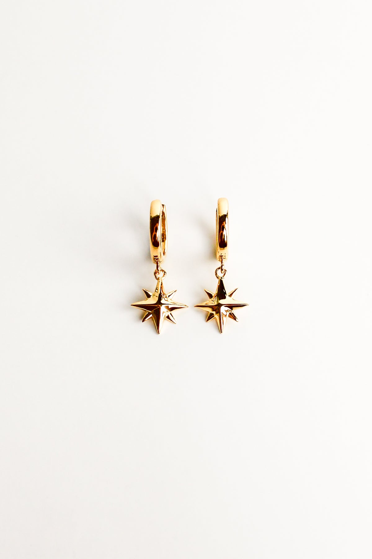 Stella Hoops in 18k gold vermeil, solid north star charm drop huggie hoop earrings, white background, Ether Jewelry