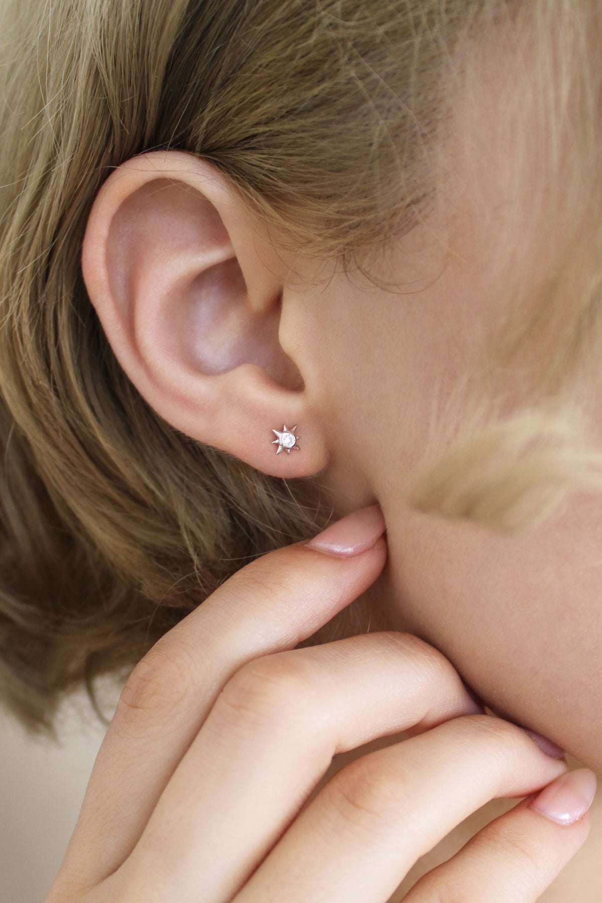 Sterling silver Stella Stud Earrings close-up on model ear, north star CZ stud earring detail, Ether Jewelry