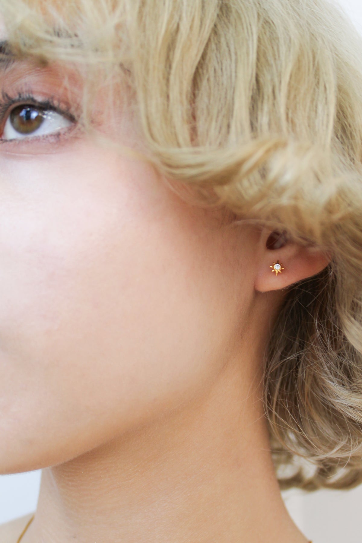 Stella Stud Earrings in 18k gold vermeil on model, dainty north star CZ stud earrings, Ether Jewelry