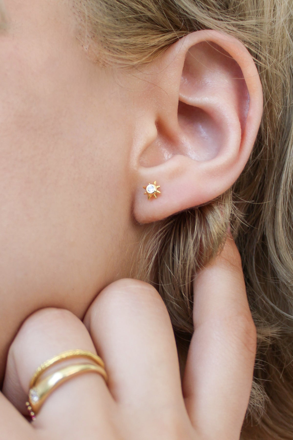 18k gold vermeil Stella Stud Earrings close-up on model ear, north star CZ stud earring detail, Ether Jewelry