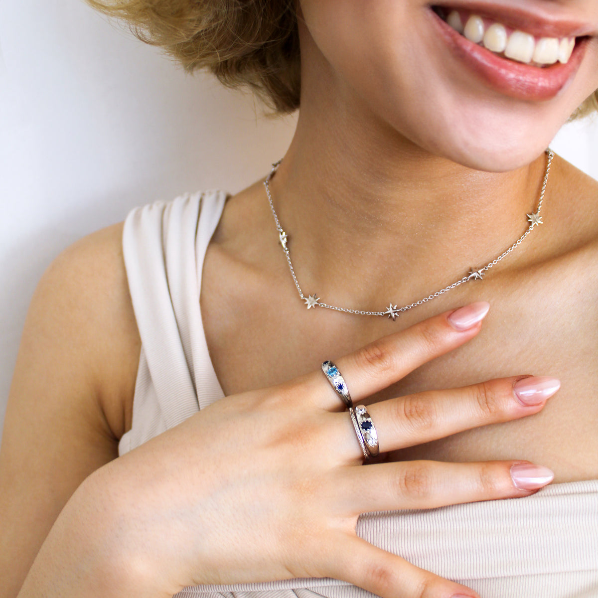 Sterling silver Victorian Roma Ring close-up on model hand, three stone gypsy set domed band, styled with juno necklace, Ether Jewelry