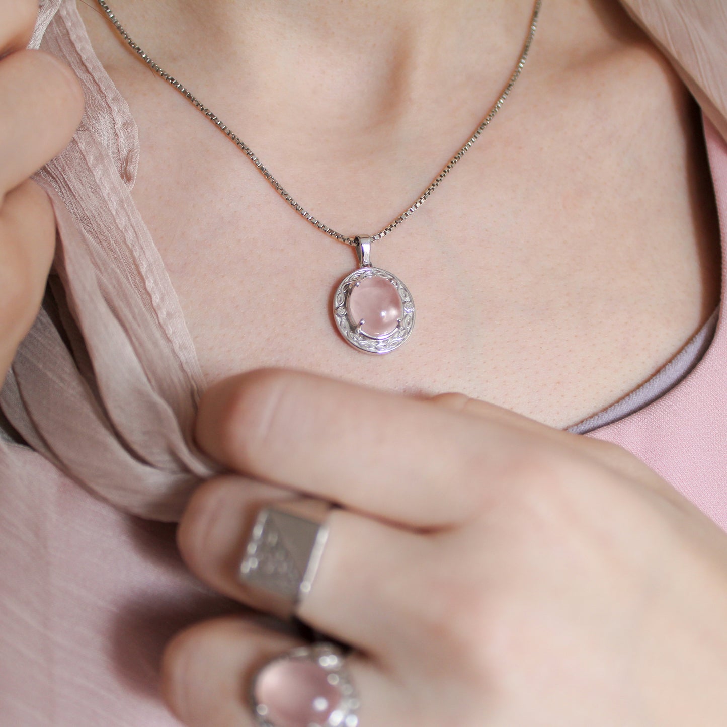 Romantic Heir Necklace with a pink quartz gemstone pendant worn by a person