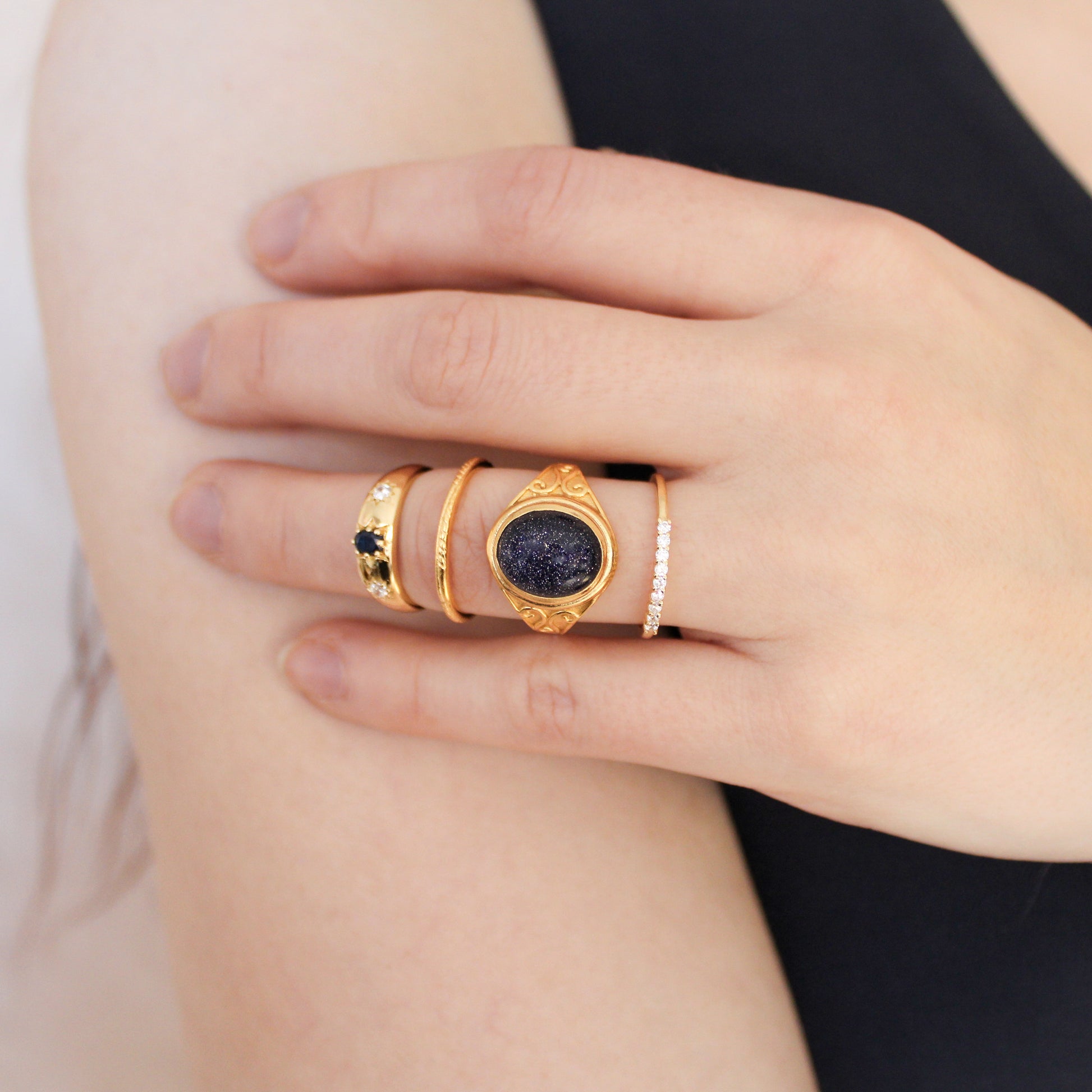 Night Keeper Ring in 18k gold vermeil worn with multiple rings on model finger, blue sandstone signet ring, Ether Jewelry